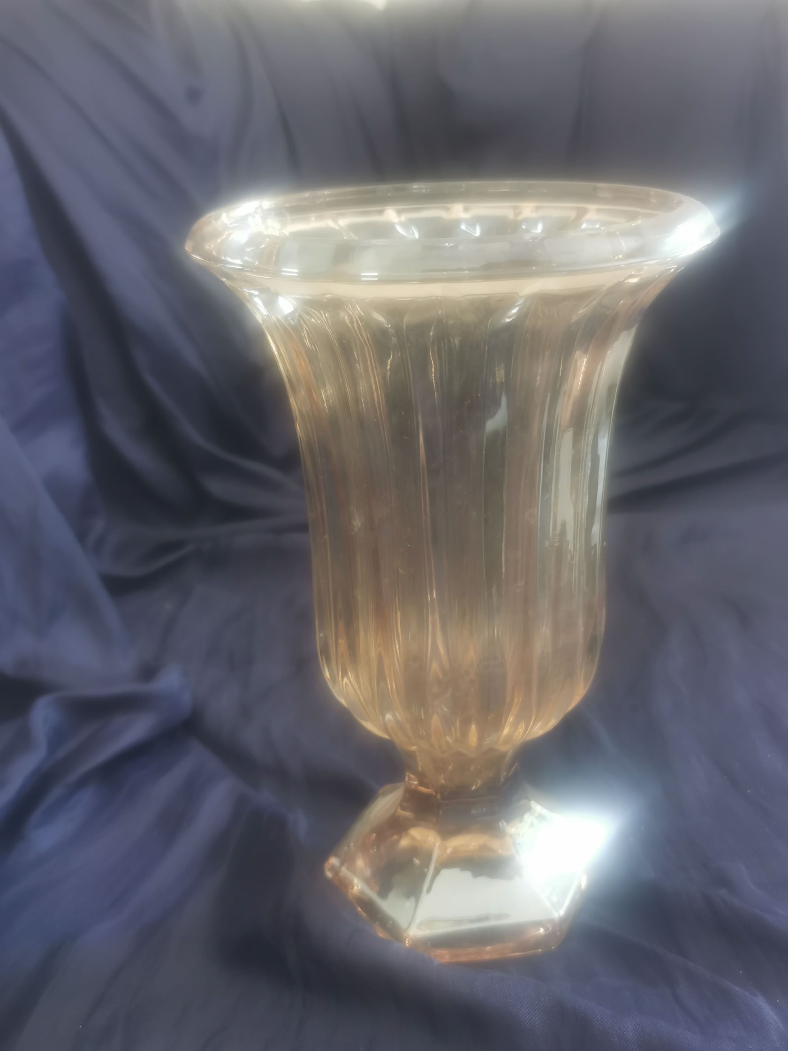 Tall amber/brownish glass vase with fluted (ribbed) body and pedestal base
